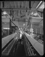 Assembly line workers filling bottles of drinking water at the Arrowhead-Puritas plant, Los Angeles, 1929-1939