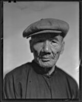 Asian-looking man, probably in Will Connell's photography studio, 1930-1960