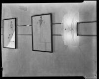 View of two framed fashion illustrations and an art deco sconce in "Irene LTD," a dress shop of designer Irene Lentz Gibbons, Los Angeles, (circa 1930?)