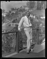 Stanley Reckless standing on a balcony of his home overlooking in the Silver Lake neighborhood, Los Angeles, 1930-1939