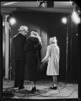 Actors dressed and posed as parents and a daughter at a photo shoot for Sunkist dental, 1935