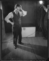 Man standing on a set during a photo shoot to advertise products, 1925-1939