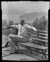 Stanley Reckless seated on a balcony of his home overlooking Silver Lake, Los Angeles, 1930-1939