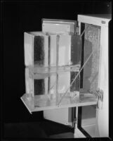 Icebox with blocks of ice on a pull-out shelf, 1930-1937