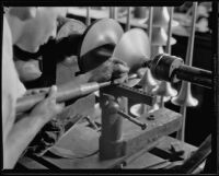 Technician making a brass horn at the F. E. Olds and Son plant, Los Angeles, 1933-1939