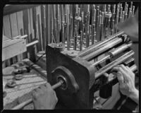 Machine in use at a work bench at the F. E. Olds and Son plant, Los Angeles, 1933-1939