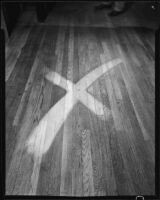 Wood floor with an "x"-shaped area cleaned with "Double X Floor Cleaner," circa 1934