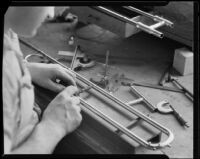 Technician making a brass horn at the F. E. Olds and Son plant, Los Angeles, between 1933-1939