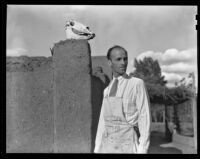 Walter Willard "Spud" Johnson standing next to a Pueblo Revival building, Santa Fe or Taos, 1932