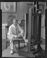 Stanley Reckless painting in the studio of his Silver Lake home, Los Angeles, 1930-1939