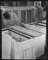 Two men assembling iceboxes, 1930-1937