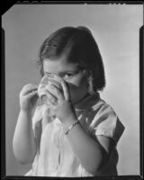 Little girl drinking a cup of Ghirardelli cocoa