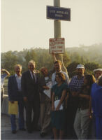 A group, including Tom LaBonge and Lewis MacAdams, with the Los Angeles River sign