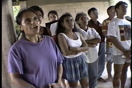 Darwin Australia, 1993: Timorese refugee choir with uncle of resistance leader Xanana Guzmal, Australian government burns Timorese refugee boats