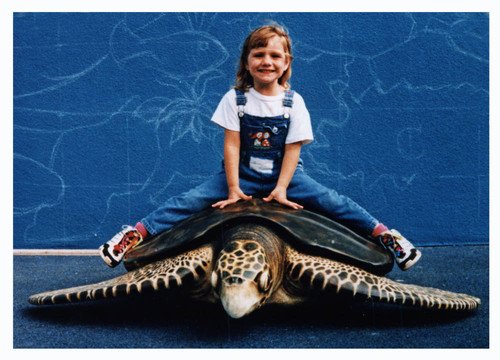 Alana rides a sea turtle