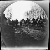 On a road near the bazaars, Thomas Allen on his bicycle as curious Kirghiz and Sarts follow on horseback, Chinaz, Uzbekistan, 1891