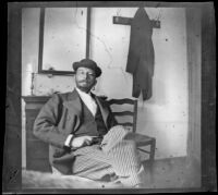 Man seated in the room of a home or hotel, Turkey, 1895