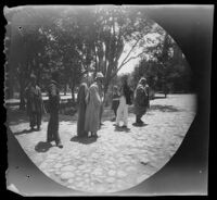 American missionary William Whipple, Thomas Allen, and beggars in the courtyard of "Amir Caravanserai," Tabrīz, Iran, 1891