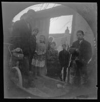 William Sachtleben next to his bicycle conversing with Athenian children, Athens, 1891