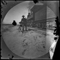 William Sachtleben with his bicycle standing next to a train, Asia, 1891