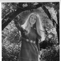 Laura Harrison, Miss Sacramento 1972, standing outside under a tree branch