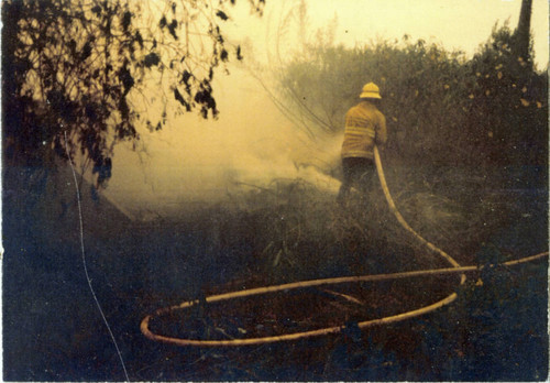 Firefighter with hose — Calisphere