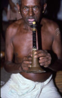 Kunyāttu Kārnavar playing a kuzhal, a double-reed wind instrument ...