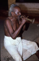 Kunyāttu Kārnavar playing a kuzhal, a double-reed wind instrument ...
