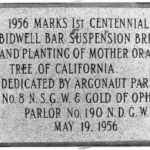 View of historical marker sign commemorating the centennial of the Bidwell Bar Bridge and the Mother Orange Tree of California