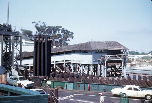 Cars exit the ferry onto access roads through the landing structure, Coronado, circa 1968