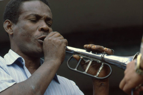 Man Playing the bugle at the Blacks and Whites Carnival, Nariño, Colombia, 1979
