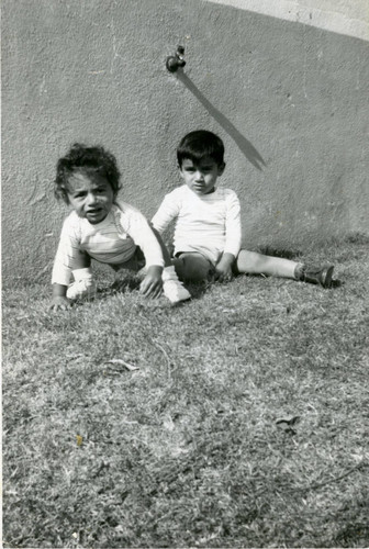 Two Muñoz brothers sitting on the grass, East Los Angeles, California