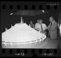 Disney imagineers examining a model of Disney World's Space Mountain, 1973