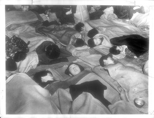 "The End of homecoming day finds arrivals from Communist China tucked in bed at reception center. Leftists, planted among repatriates, demanded that they be allowed to leave at their will."--caption on photograph