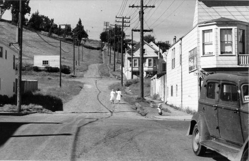 [Two girls walking down a dirt road in Visitacion Valley]