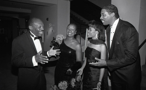 Willie Brown speaking with others at a formal event, Los Angeles, 1989