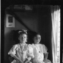 Two young girls in window