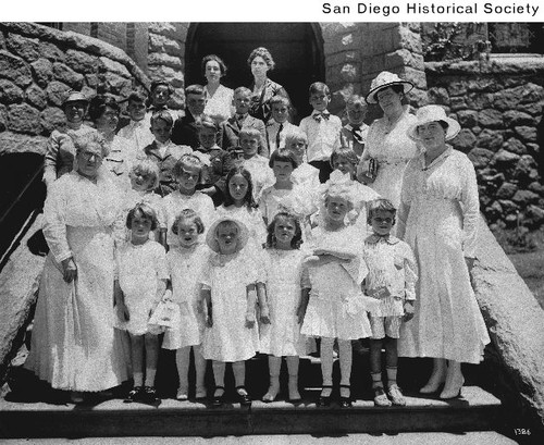 Women and children dressed in white, standing on the steps of the First Congregational Church at Sixth and A Street