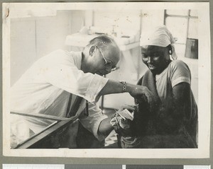 Treating an infant, Chogoria, Kenya, ca.1940