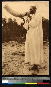 Blowing a horn as a call to prayer, Uganda, ca.1920-1940