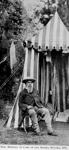 Portrait of John Bidwell sitting in front of a tent