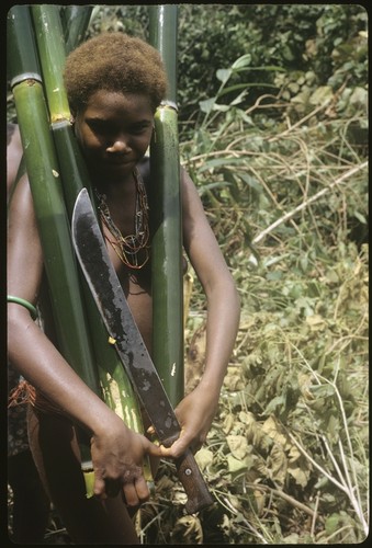 Woman carrying water bamboos