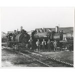 Engineers and crew pose in front of a pair of Howard Terminal Railway trains