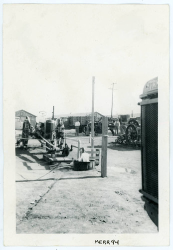 Photograph of a tractor motor being used to pump water at Manzanar