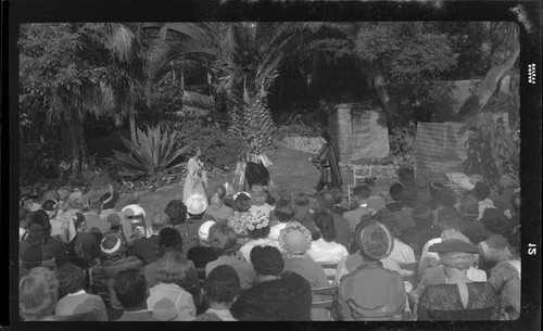 Audience watching outdoor theatrical performance, perhaps Shakespeare, [Santa Monica?], 1956-1957