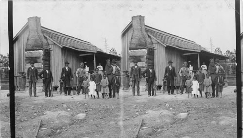 Negro family beside log cabin. North Carolina