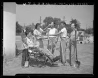 Mrs. Paul Vollandt serving drinks to volunteers who landscaped garden for her disabled husband in El Monte, Calif., 1947