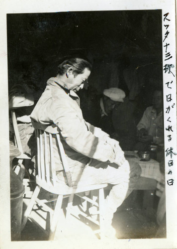 Nisei man resting on a chair