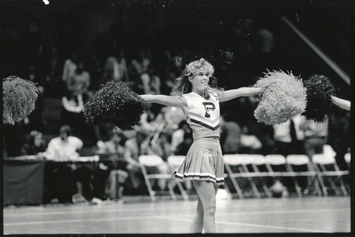 Waves cheerleader during routine, 1985