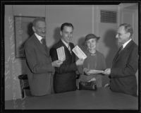 Fred Cole awards checks to sweepstakes winners Dr. Albert E. Finn, Evan Briggs, and Grace Witherill, Los Angeles, 1935